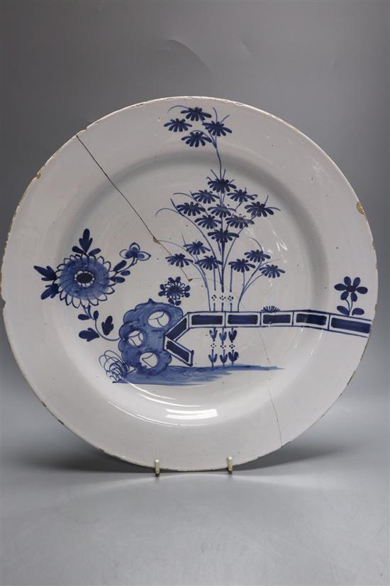 Two 18th century Delft blue and white dishes and a similar English delftware dish, 34-35cm, all a.f.